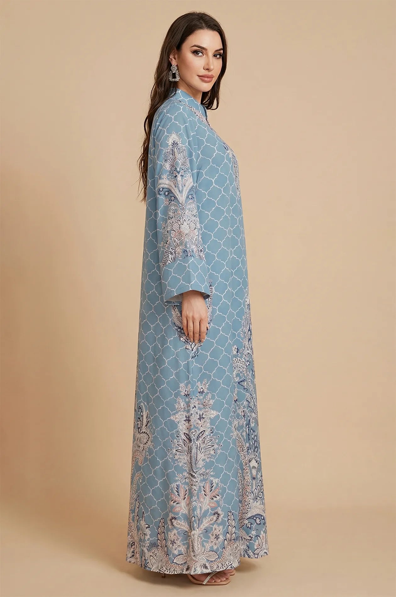Side profile of the Nirea blue paisley print kaftan at Naylara, showcasing the fluid maxi-length drape and long sleeves.