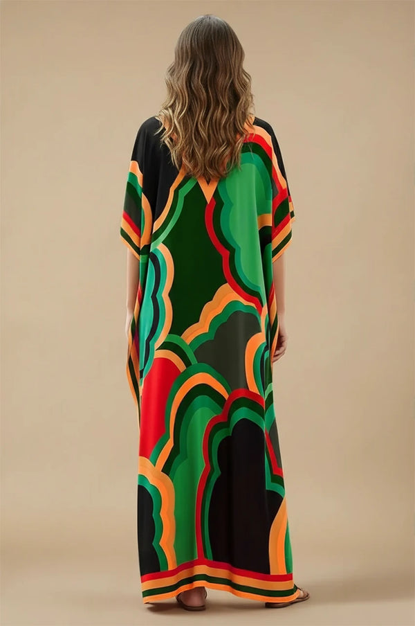 Model wearing Novah green tropical kaftan with bold multicolor print, full-length back view