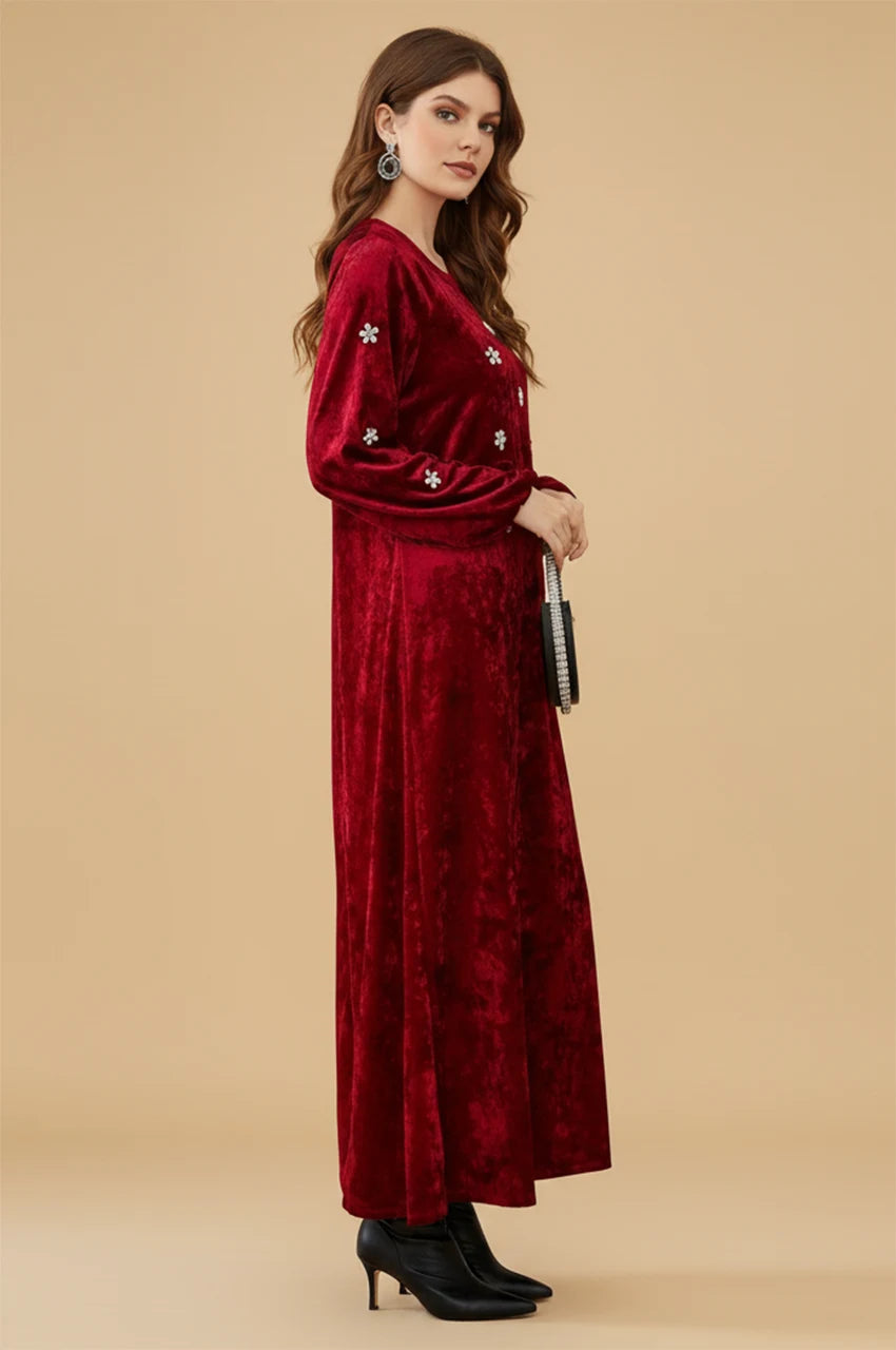 Side profile of the Oriya ruby kaftan dress showing bishop sleeve detail.