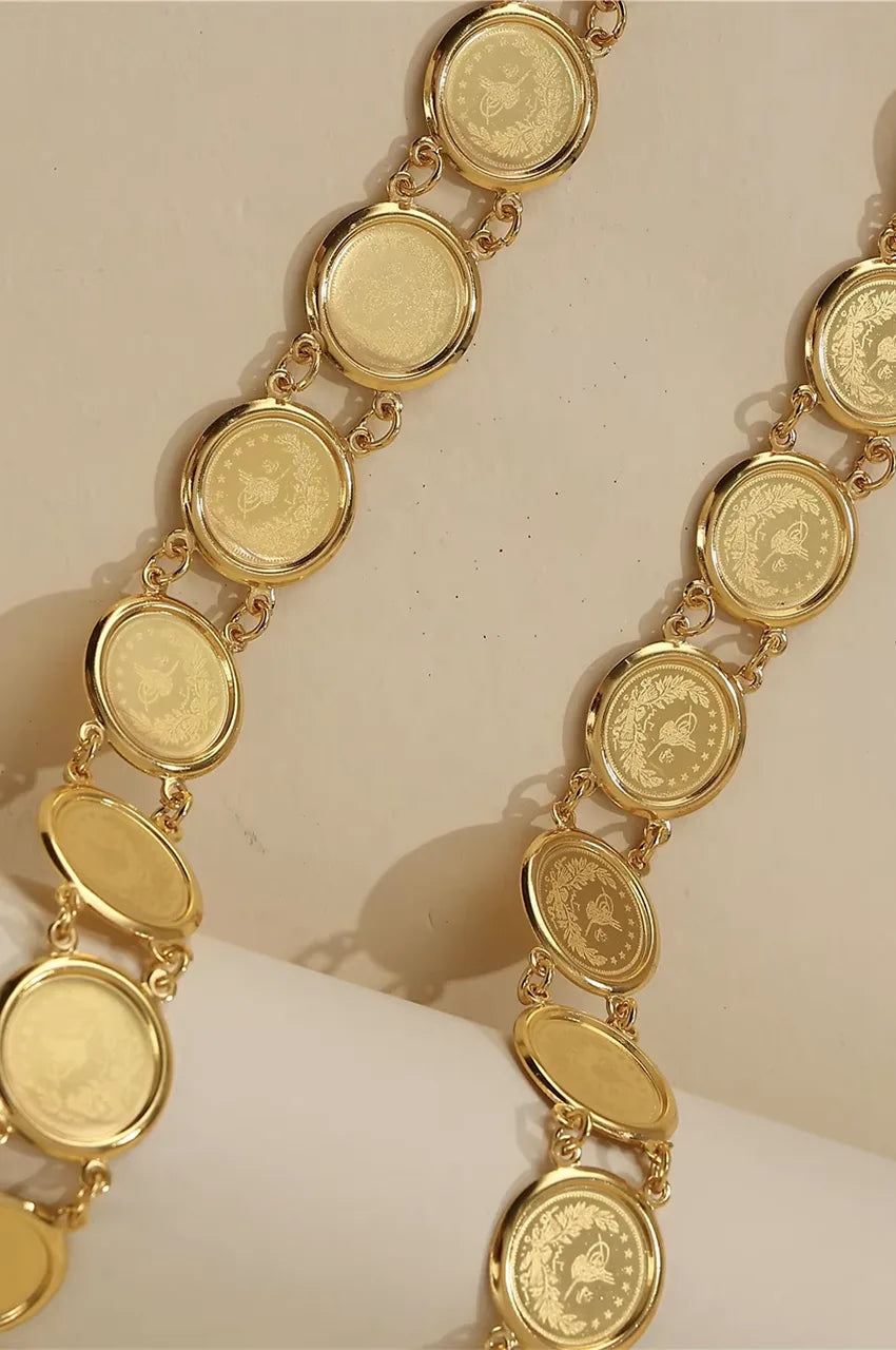 Macro detail of the gold metal coins featuring traditional Ottoman tughra calligraphy.