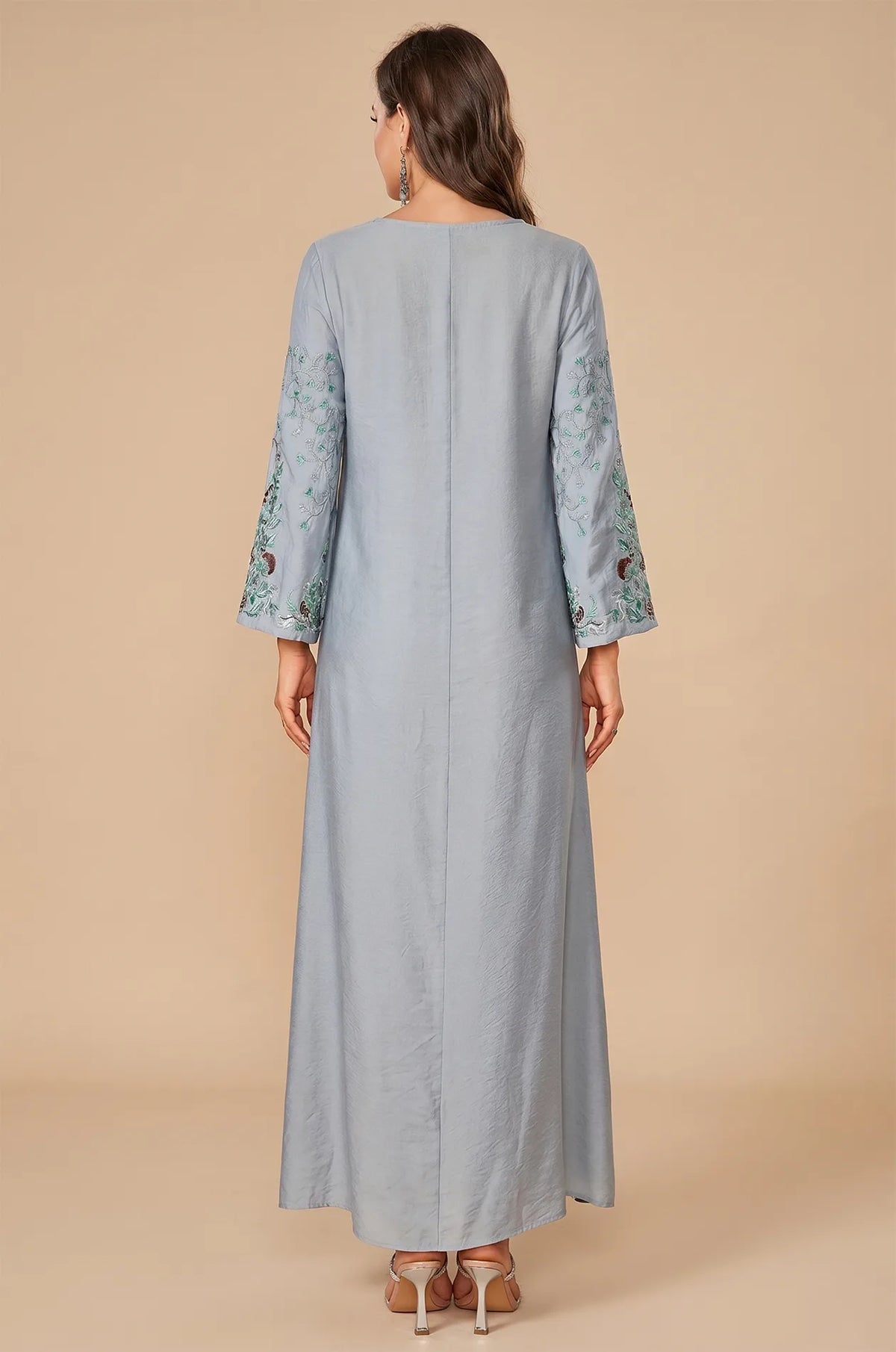 Rear view of the Petra dusty blue kaftan showing the fluid drape.