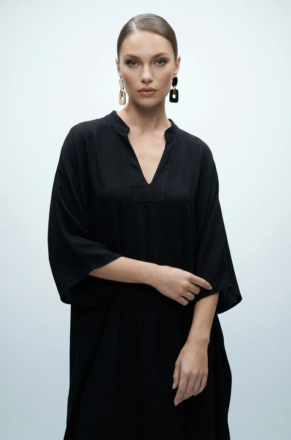 Woman wearing black plain kaftan front detail with split V-neckline
