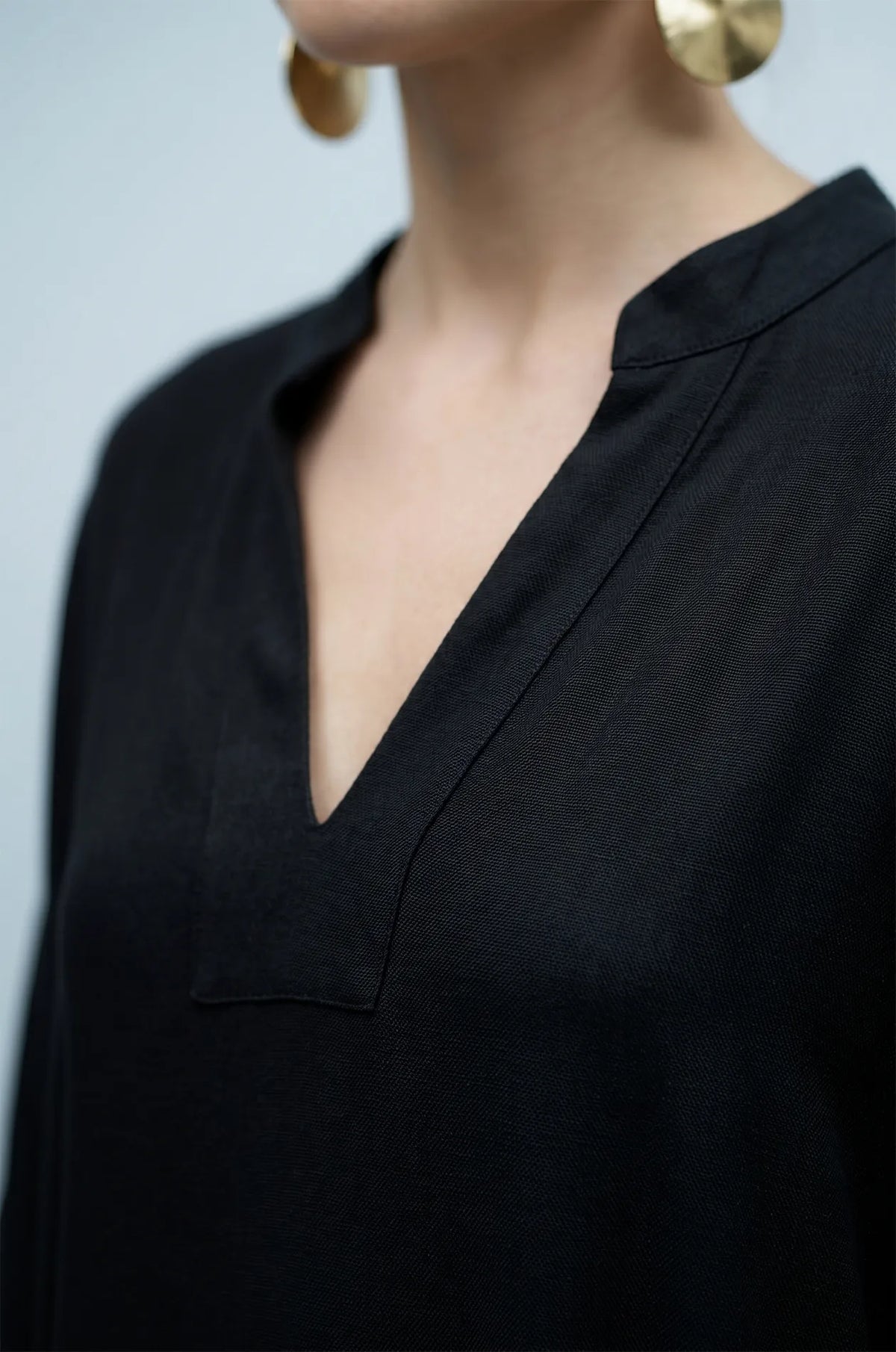 Close-up of black plain kaftan split V-neckline detail