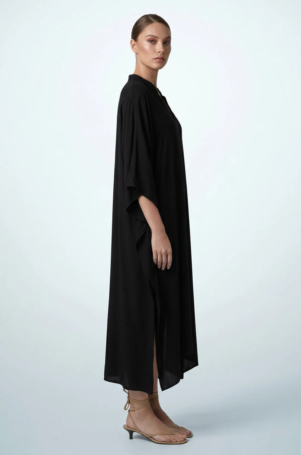 Side profile of black plain kaftan showing flowing drape and side slit