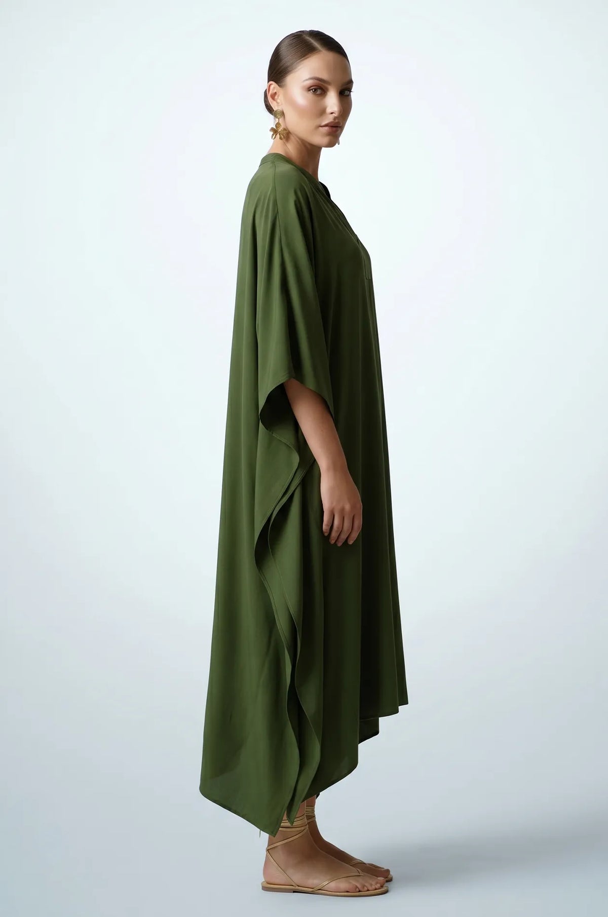 Side profile of olive green plain kaftan showing flowing drape