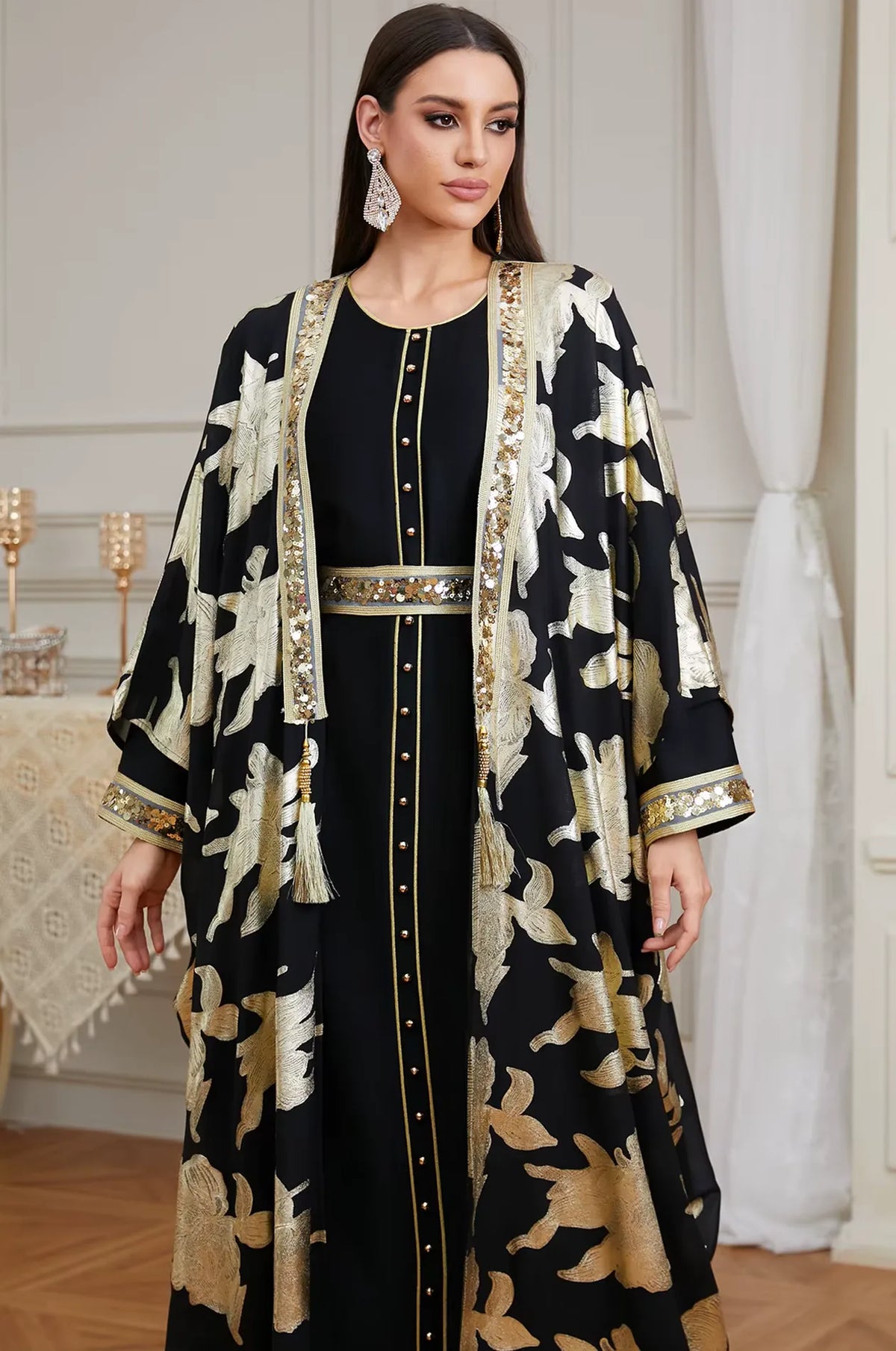 A detailed close-up of the Black Puppis kaftan luxe focusing on the gold buttons, sequined lapels, and luxury tassel accents.