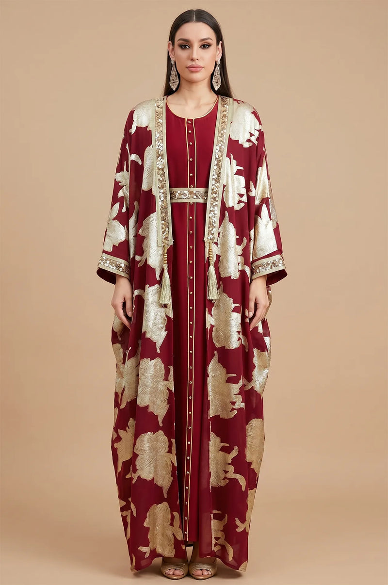 Direct front view of the red Puppis kaftan luxe featuring metallic gold floral embroidery and a shimmering sequined belt.