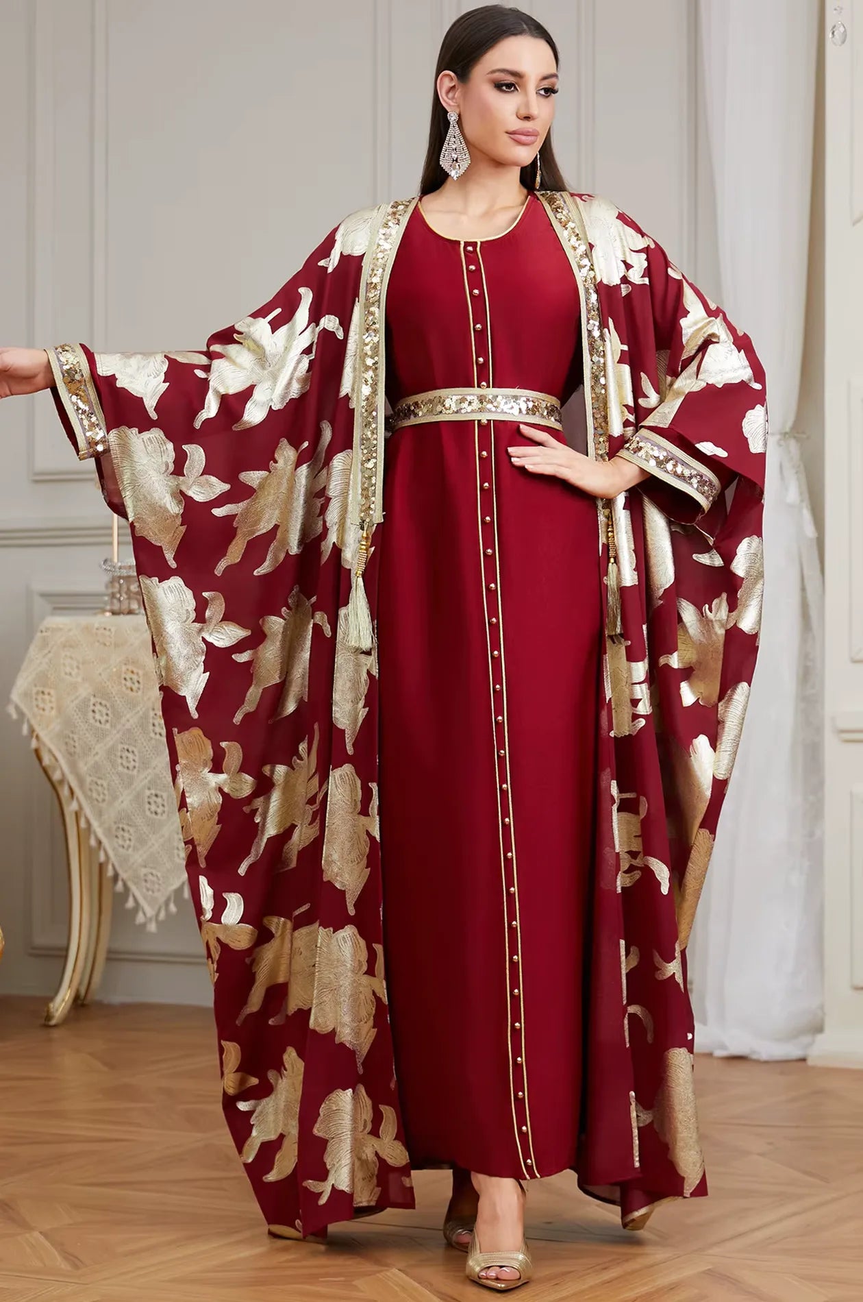A glamorous standing pose of the red Puppis kaftan luxe, perfect for a Moroccan wedding, formal party, or luxury event.
