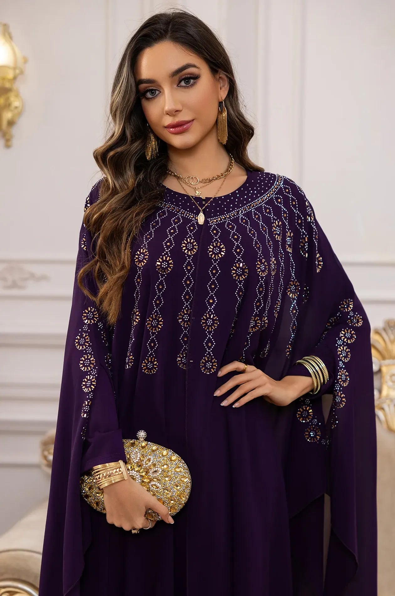 Detailed view of the embellished butterfly sleeves on the purple Cassia rhinestone kaftan.