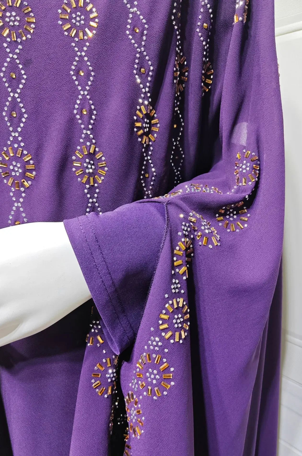 Close-up detail of the hand-placed gold and silver rhinestone embroidery on the Purple Cassia Kaftan.