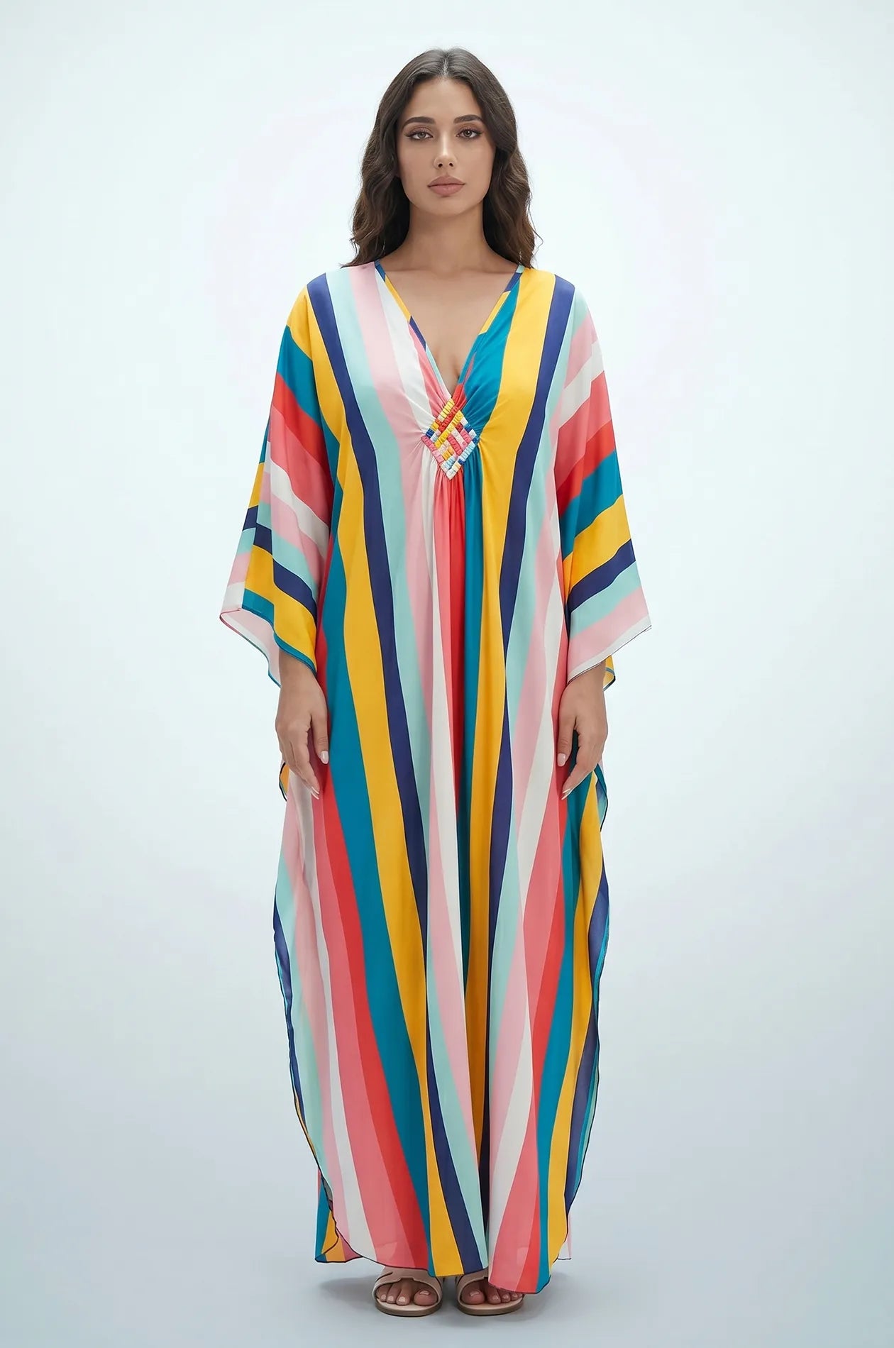 Full length studio front view of Maia rainbow striped kaftan on white background