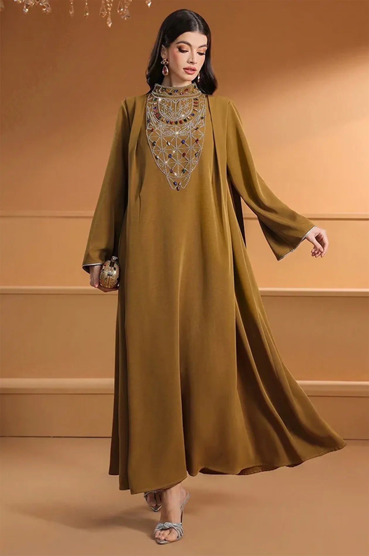 Dynamic shot of the Rami brown kaftan showing the garment's flow and silhouette.