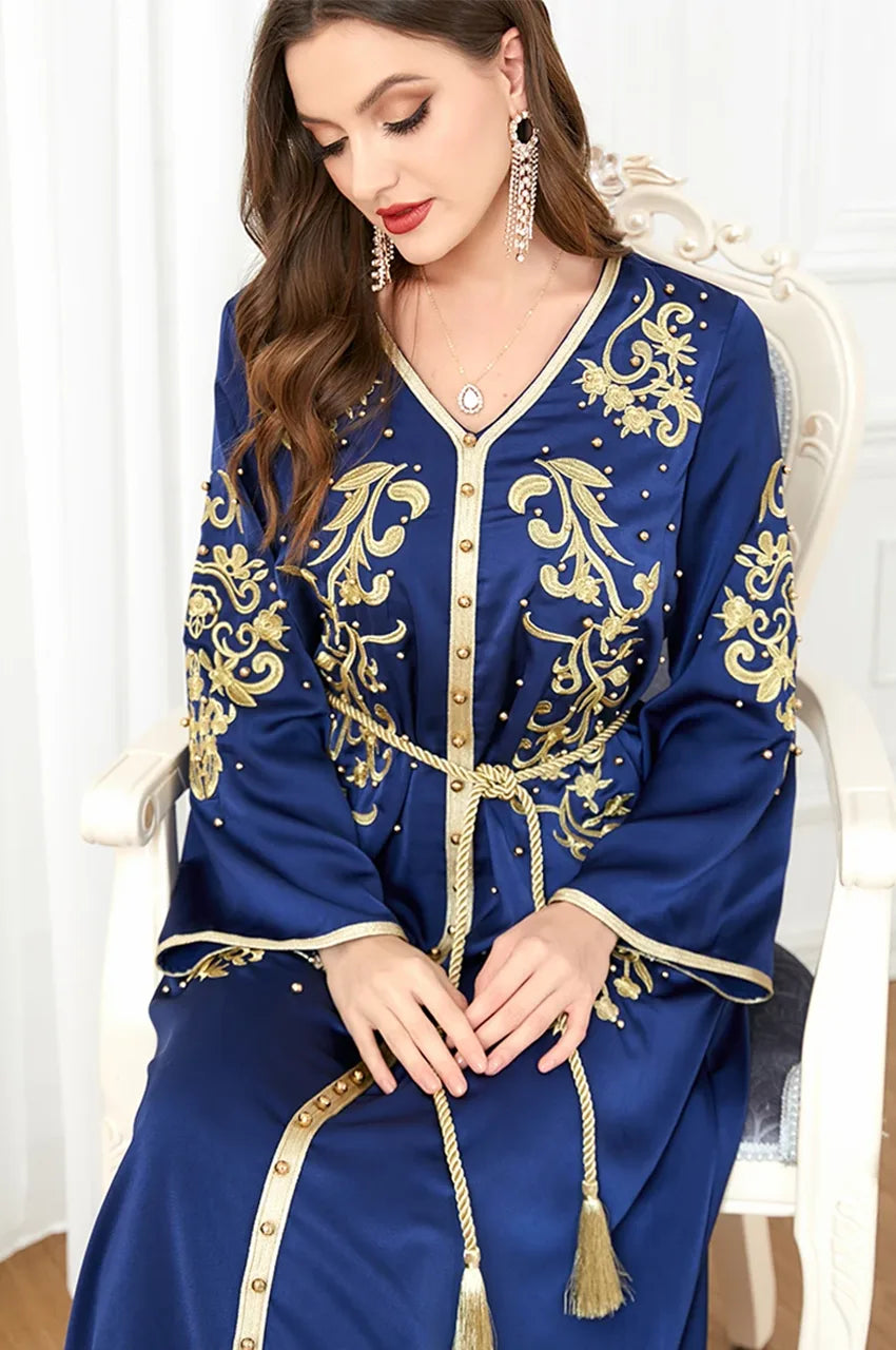 Close-up of gold embroidered blue Rayah kaftan with pearls
