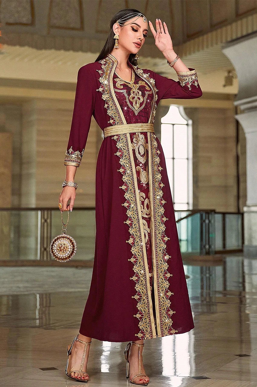 Side pose of an elegant red chiffon kaftan dress (Takchita) with gold floral embroidery and Mdamma belt.