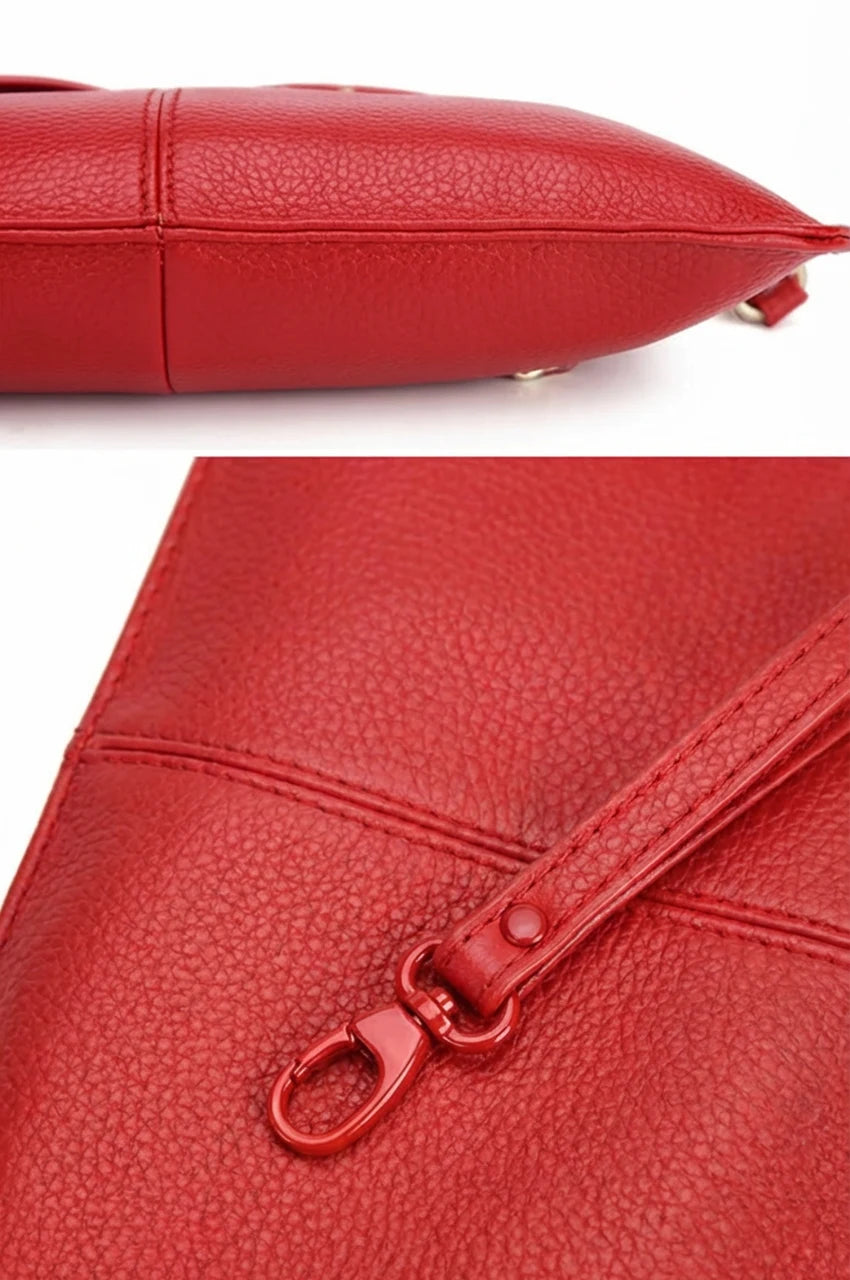 Macro detail showing the pebbled texture, stitching quality, and metal strap clip on the red leather bag.