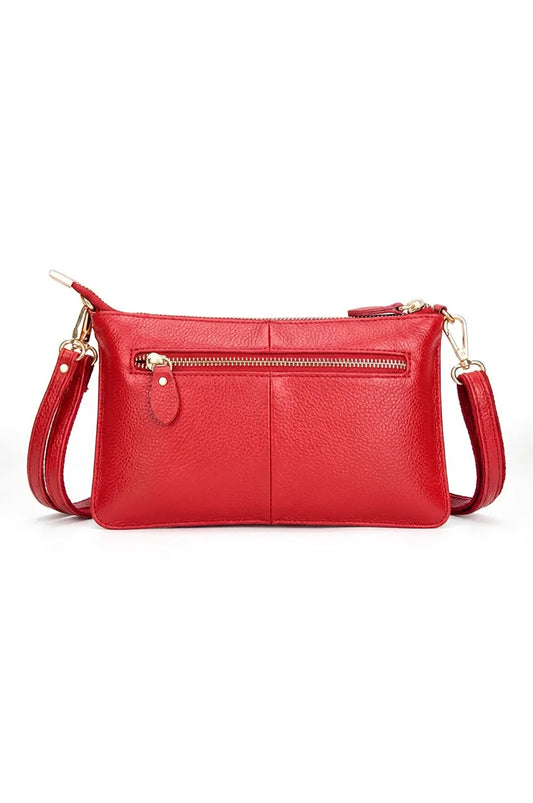 Back view of the red leather clutch bag featuring a secure zipper pocket for essentials.