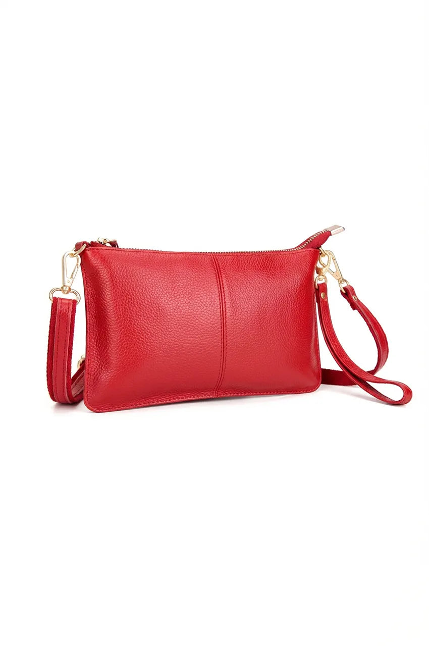 Angled shot of the red leather multi-pocket clutch bag highlighting its slim profile and functionality.