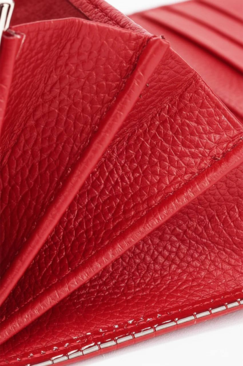 Close-up of the red wallet's interior organization showing precise stitching and multiple card slots.