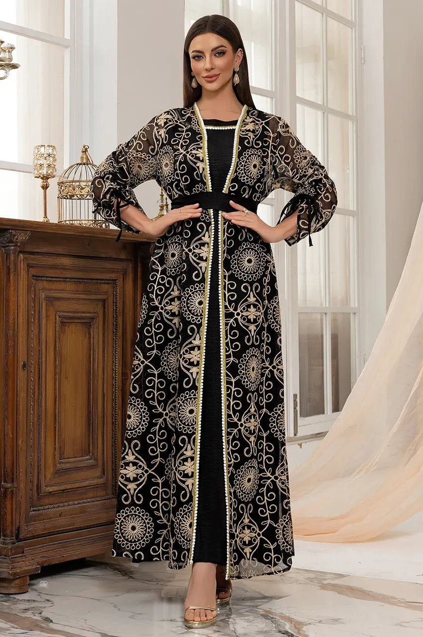 Front view of black open chiffon kaftan styled with black inner slip dress.