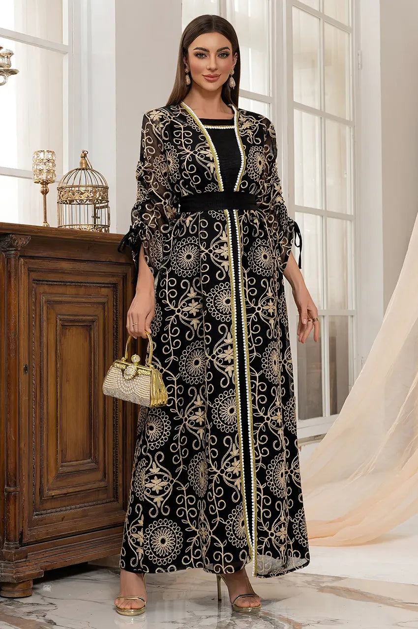 Styled Riyaa black kaftan dress with gold handbag accessory.