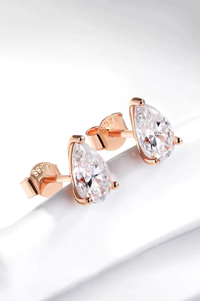 Angled view of rose gold plated pear cut earrings showing prong details.