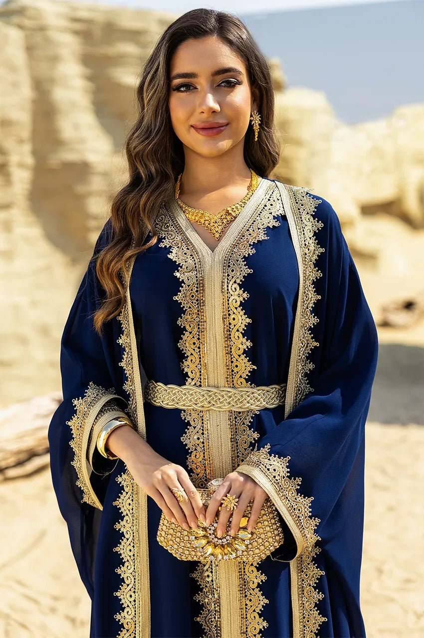 Portrait of the NAYRA royal blue long sheer kaftan styled with gold jewelry.