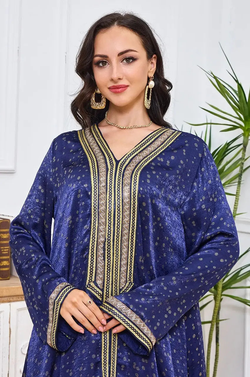 Close-up of the gold Sfifa embroidery and V-neckline on the Sabria kaftan.