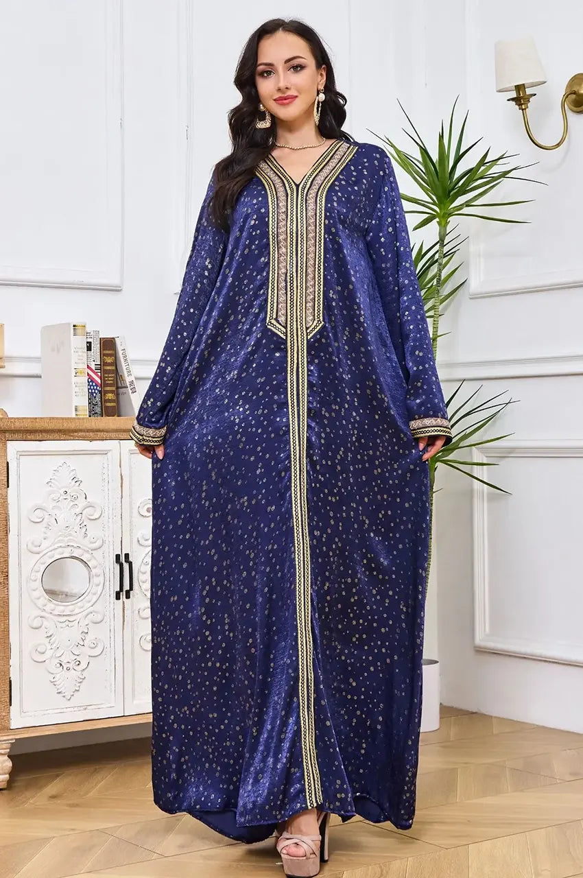 Elegant pose in the Sabria silk velvet kaftan showing the A-line drape.