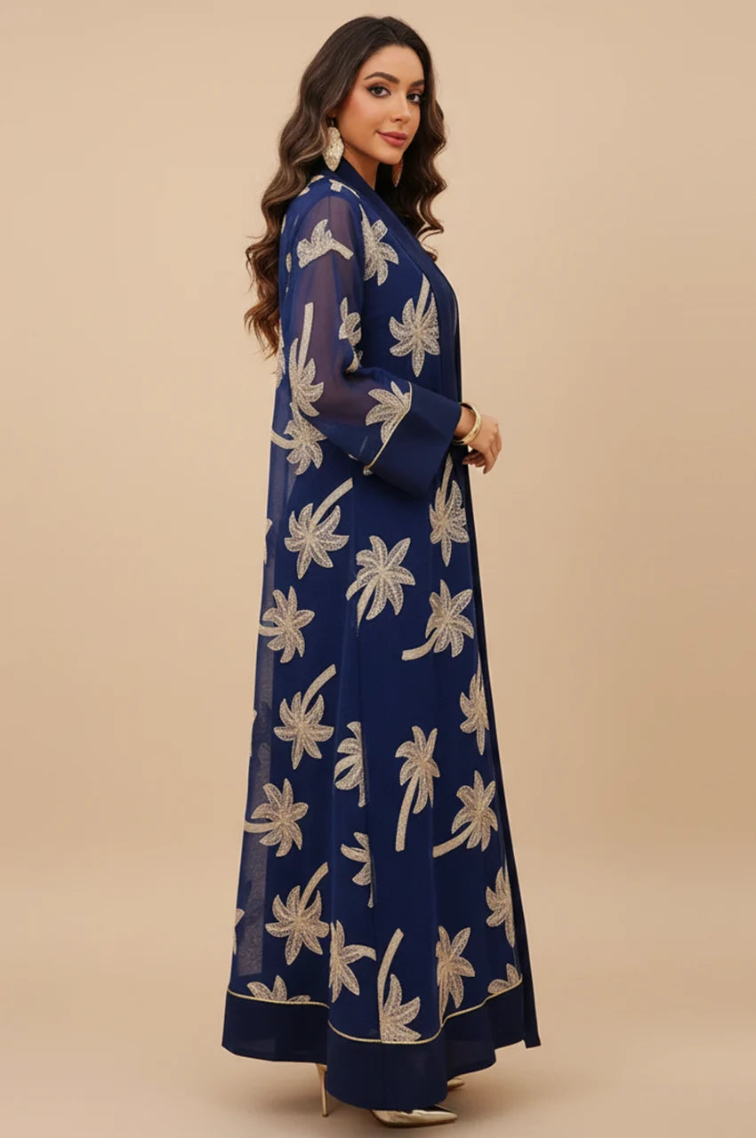 Side profile showcasing the 2-piece layering of the dark blue palm tree kaftan over the opaque slip.