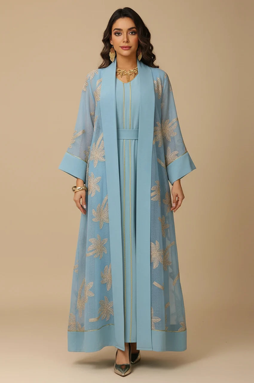 Front view of the SAELA light blue palm tree kaftan featuring gold botanical embroidery and a sheer organza overlay.