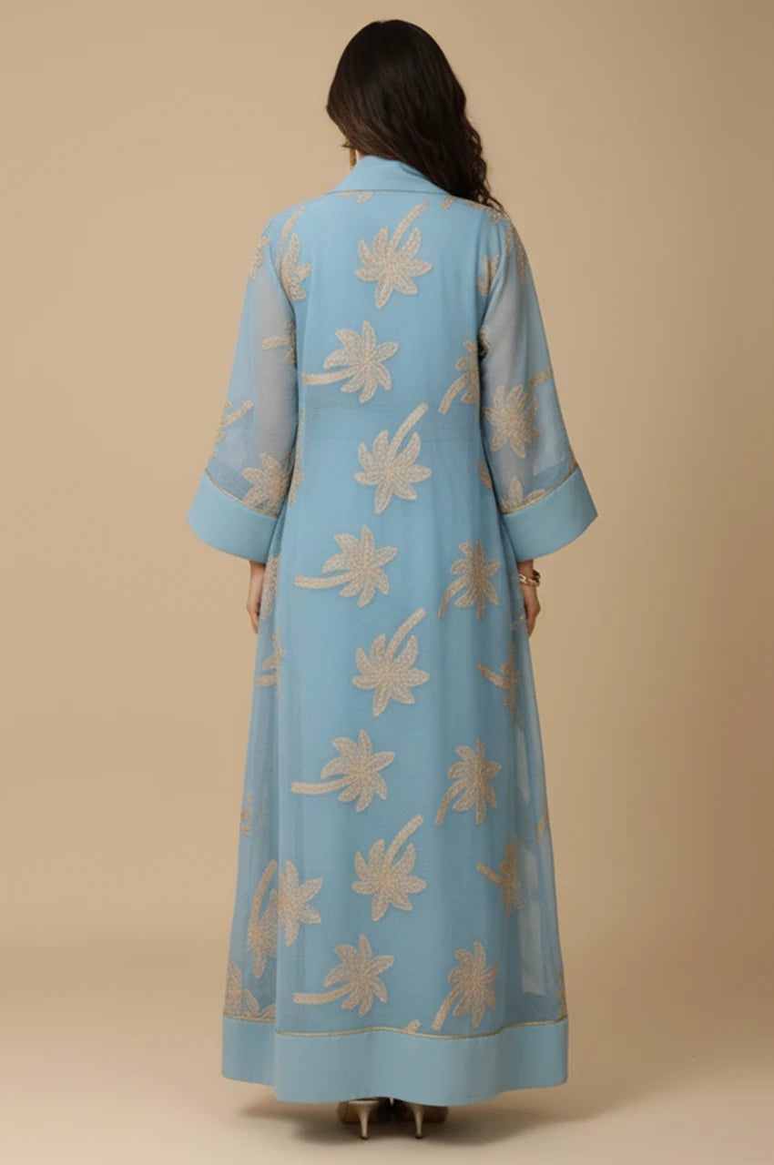 Back view of the SAELA light blue palm tree kaftan showcasing the floor-length fluid A-line drape.
