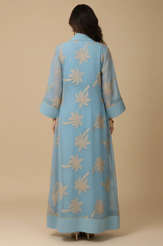 Back view of the SAELA light blue palm tree kaftan showcasing the floor-length fluid A-line drape.