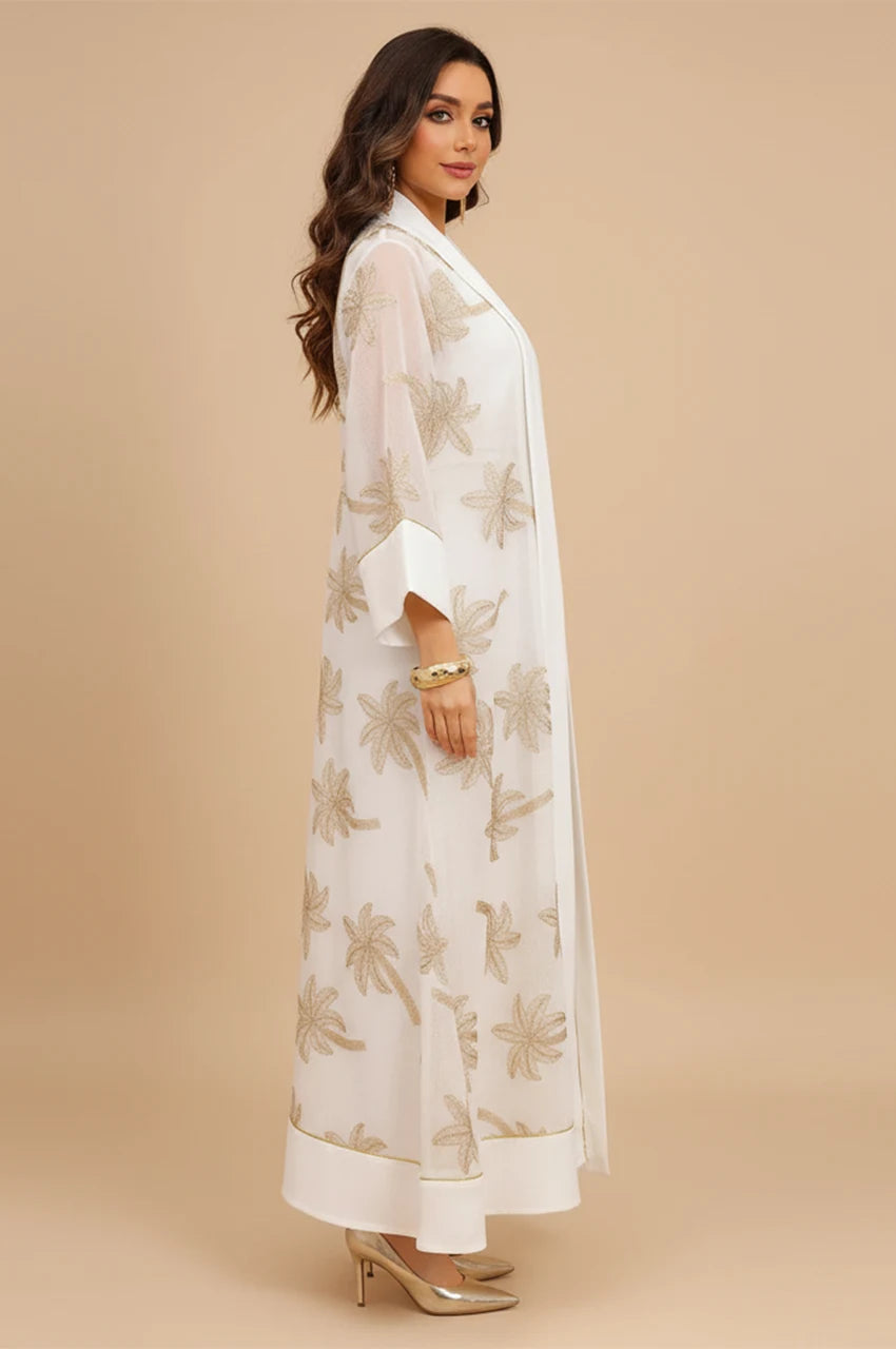 Side profile of the white palm tree kaftan highlighting the 2-piece layering of overlay and inner slip.