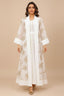 Front view of the SAELA white palm tree kaftan featuring gold botanical embroidery and a sheer organza overlay.