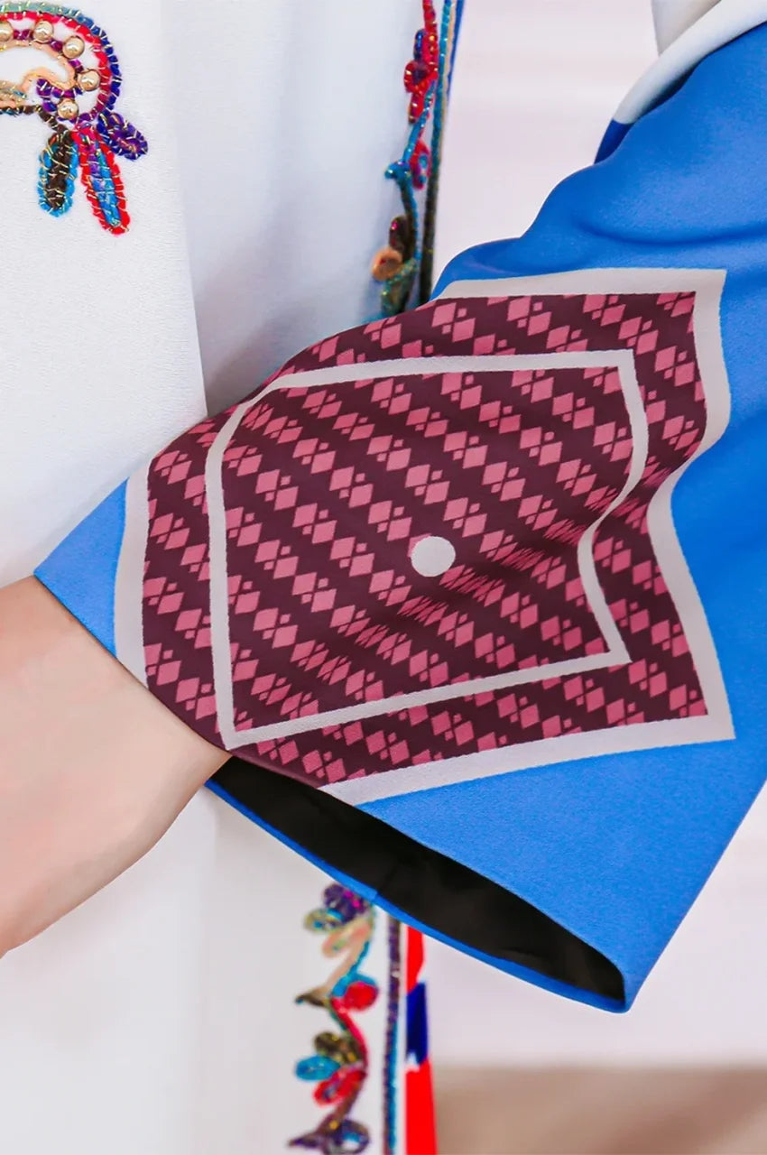 Close-up of blue patterned cuff on Safiya white embroidered kaftan