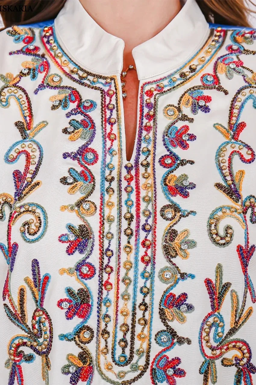 Close-up of colorful embroidery on neckline of Safiya kaftan