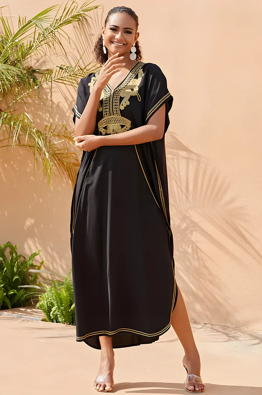 Model wearing SAHIRA Black Embroidered Beach Kaftan in sunny outdoor garden