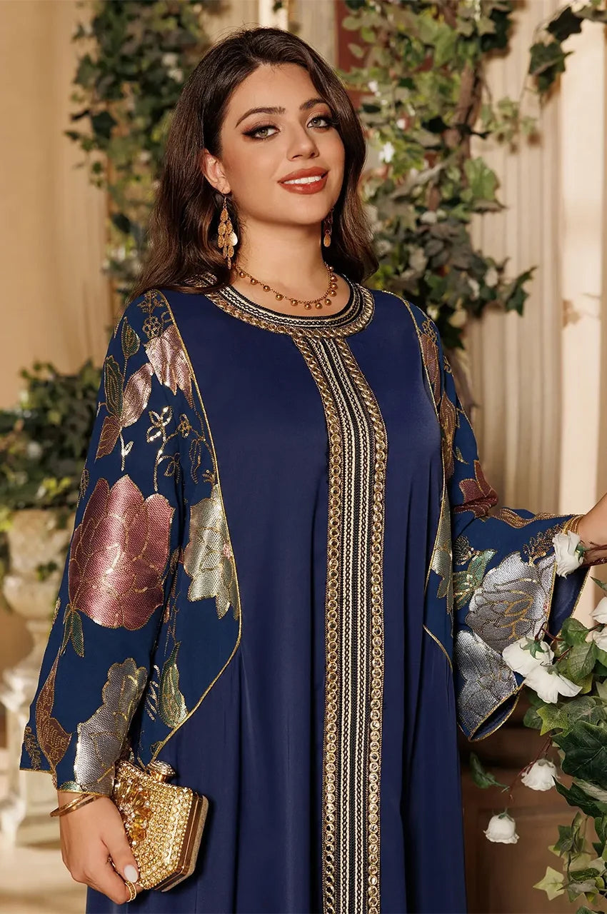 Detailed view of floral embroidered sleeve on Samira Royal Blue Pakistan Kaftan with gold metallic thread and chiffon flow.