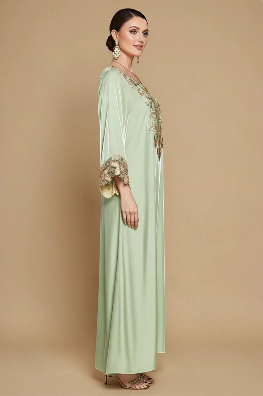 Sarai mint green satin silk kaftan showing embroidered sleeves and elegant drape – side view
