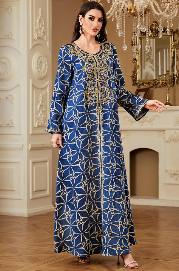 Model walking in the Selas Royal Blue textured kaftan dress by Naylara featuring gold beaded trim.