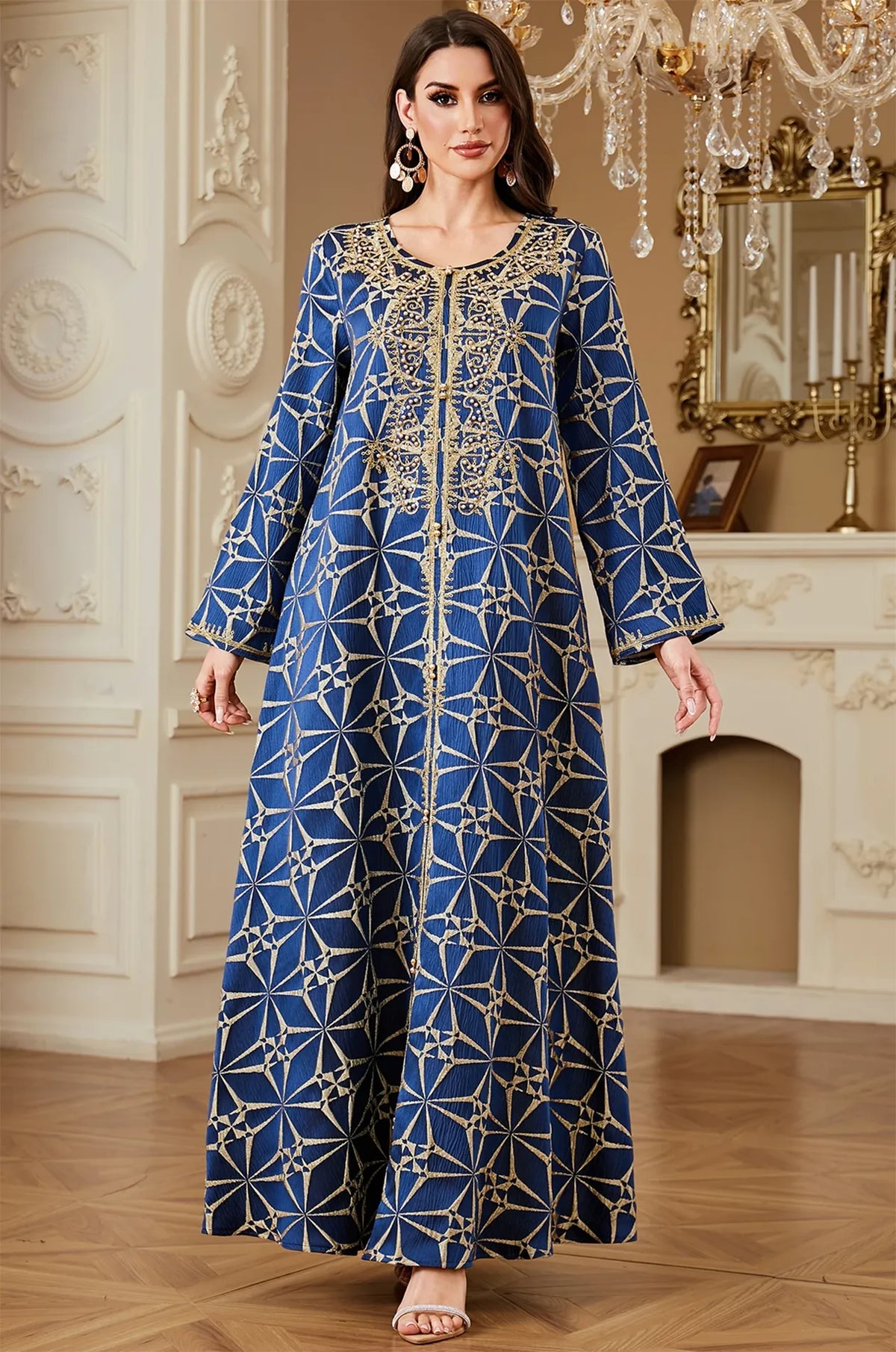 Full front shot of the Selas Blue textured kaftan dress standing in an ornate room with white wall paneling.