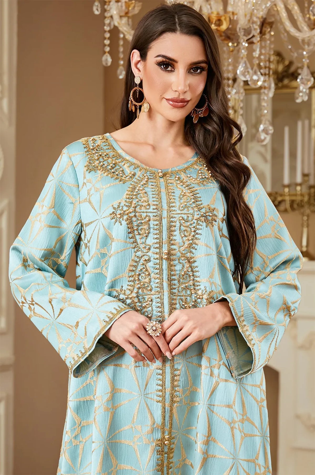 Close-up portrait detail highlighting the intricate gold embroidery and beadwork on the Selas Light Green kaftan.