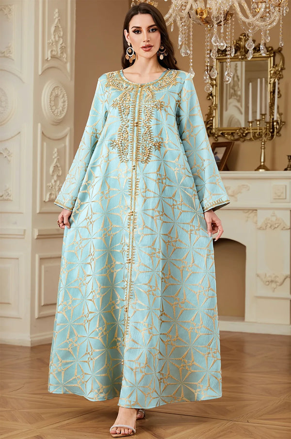 Full-length view of the Selas Light Green textured kaftan dress standing in an ornate room with a fireplace.