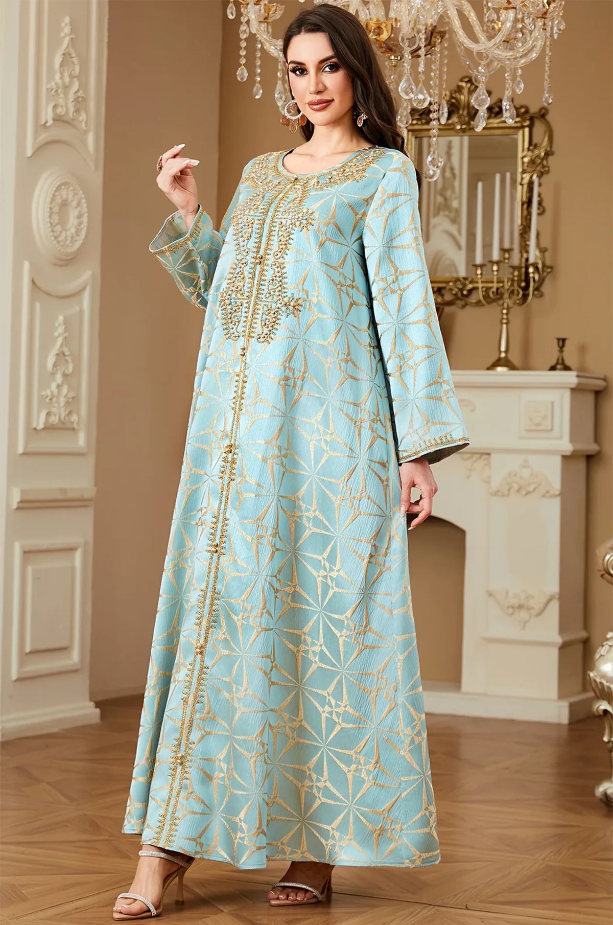 Three-quarter pose of the Selas Light Green textured kaftan dress in a luxurious interior setting with a chandelier.
