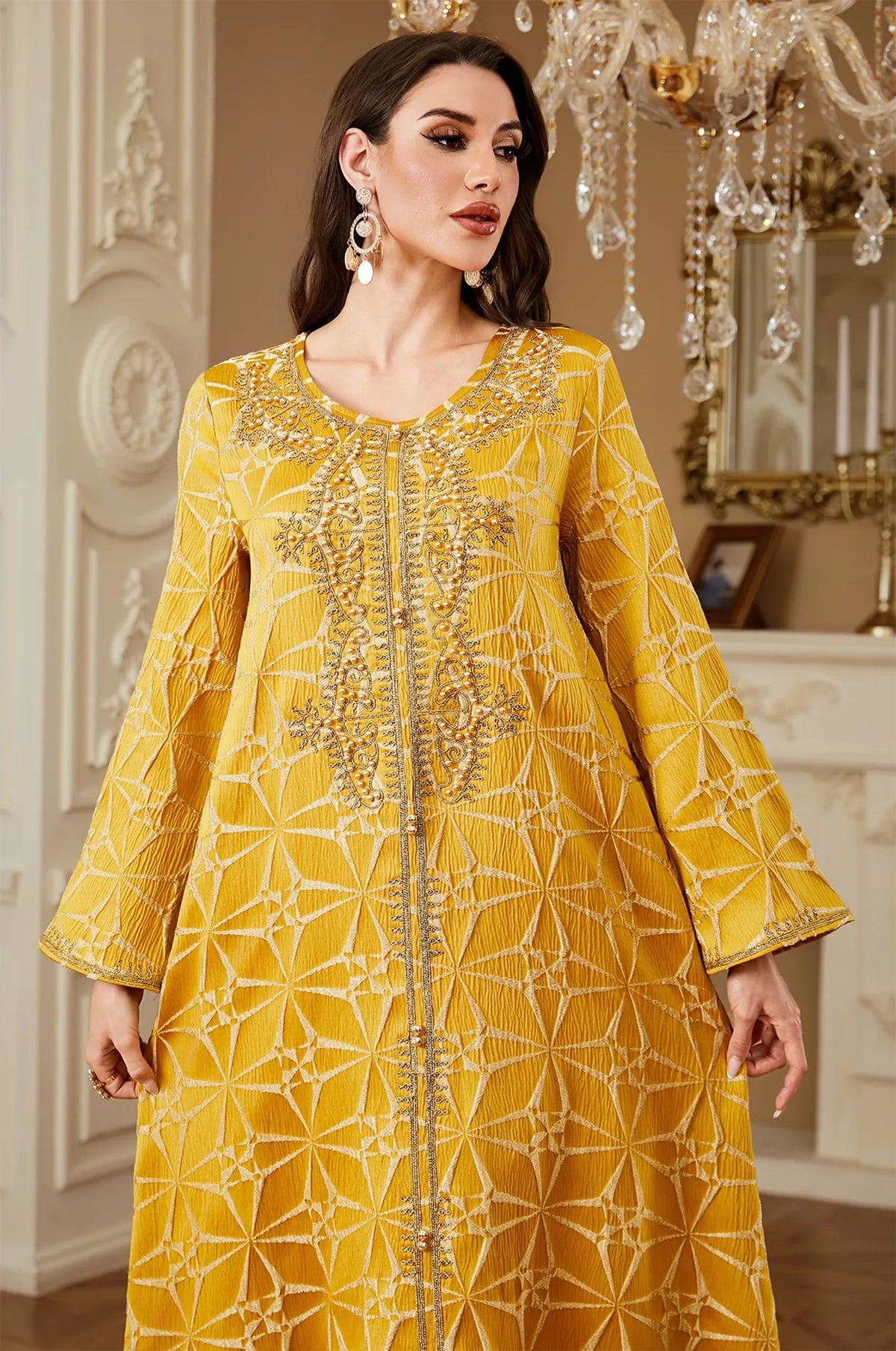 Close-up detail of the intricate gold embroidery and beaded neckline on the Selas Yellow textured kaftan.
