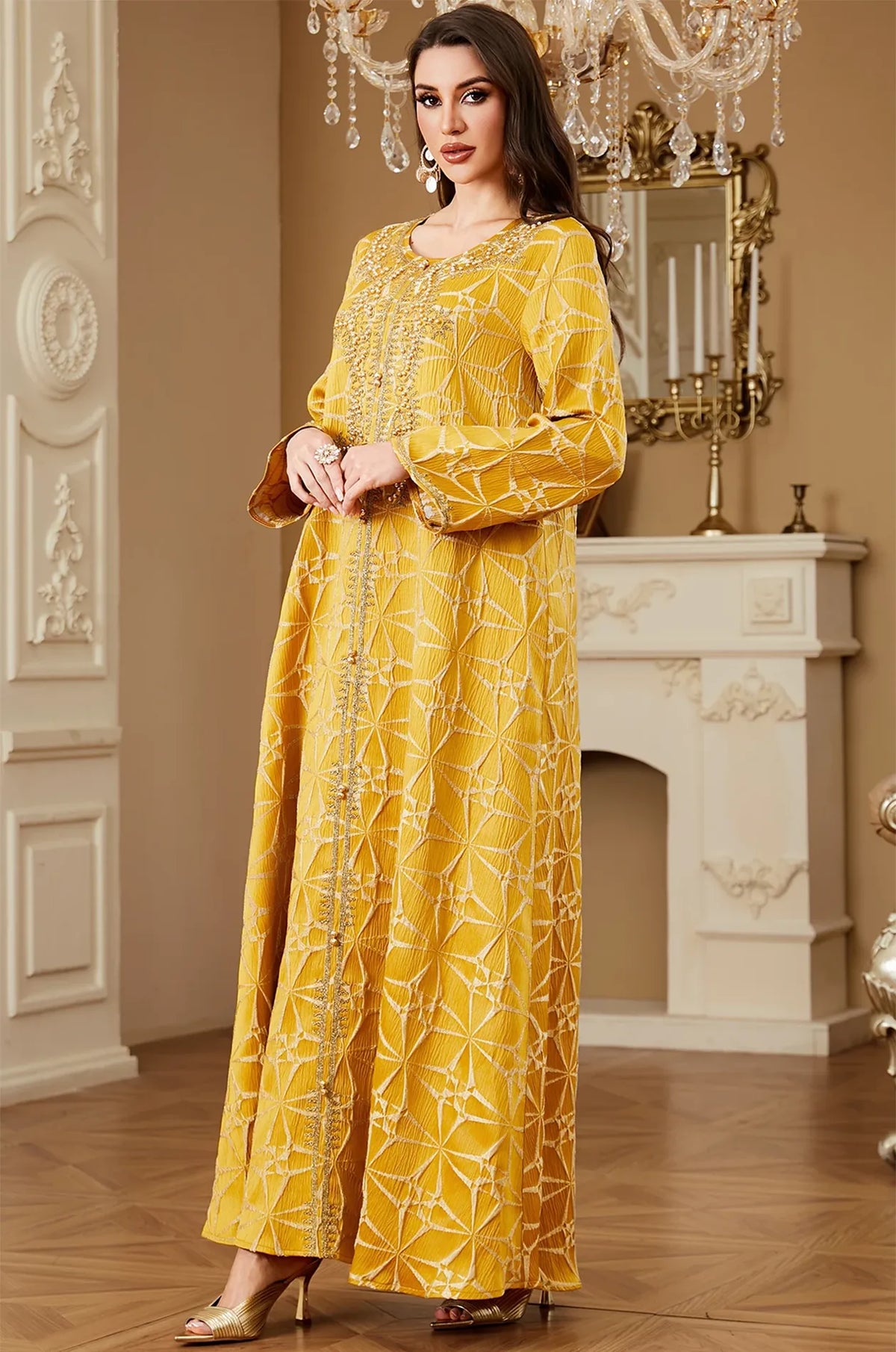 Three-quarter view of the Selas Yellow textured kaftan dress highlighting the fabric texture and gold beadwork.