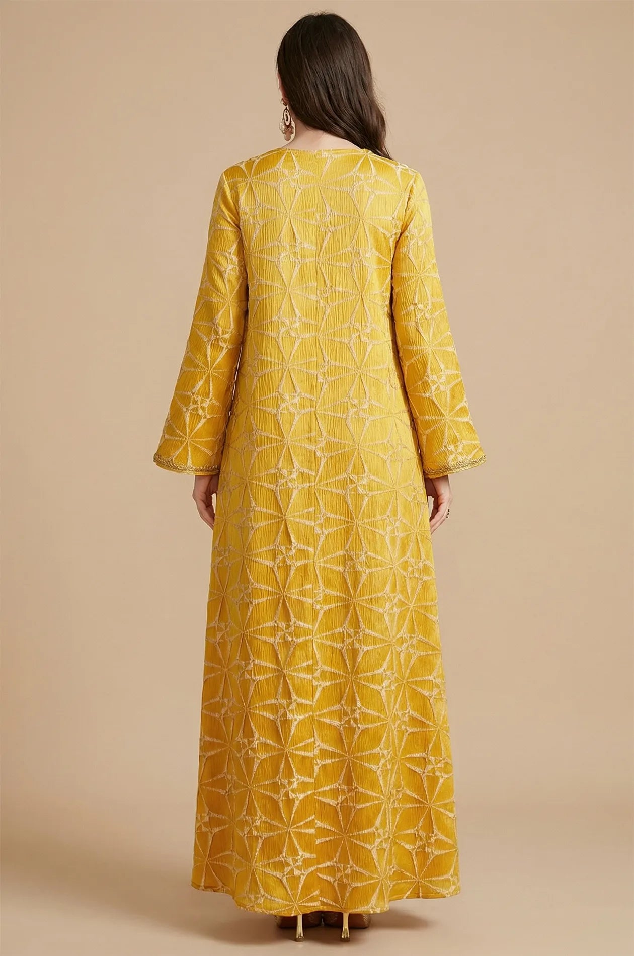 Full back view of the Selas Yellow textured kaftan dress showing the continuous geometric starburst pattern.