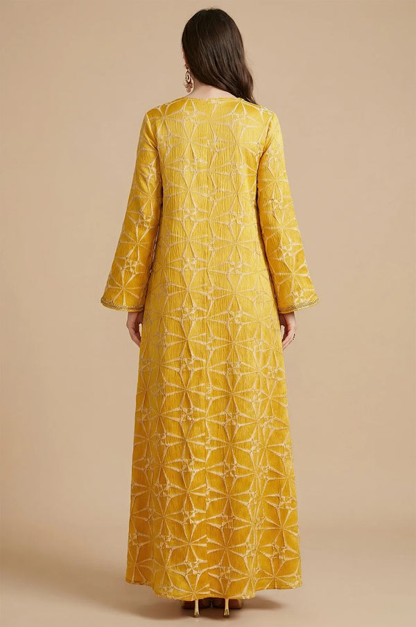 Full back view of the Selas Yellow textured kaftan dress showing the continuous geometric starburst pattern.
