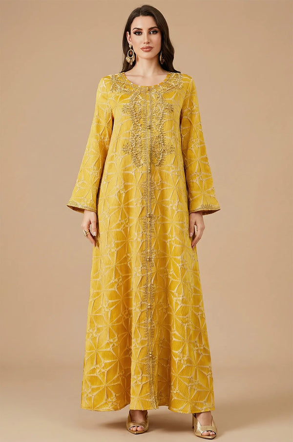 Full front view of the Selas Yellow textured kaftan dress with gold embroidery on a tan studio background.