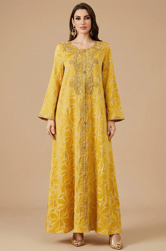 Full front view of the Selas Yellow textured kaftan dress with gold embroidery on a tan studio background.